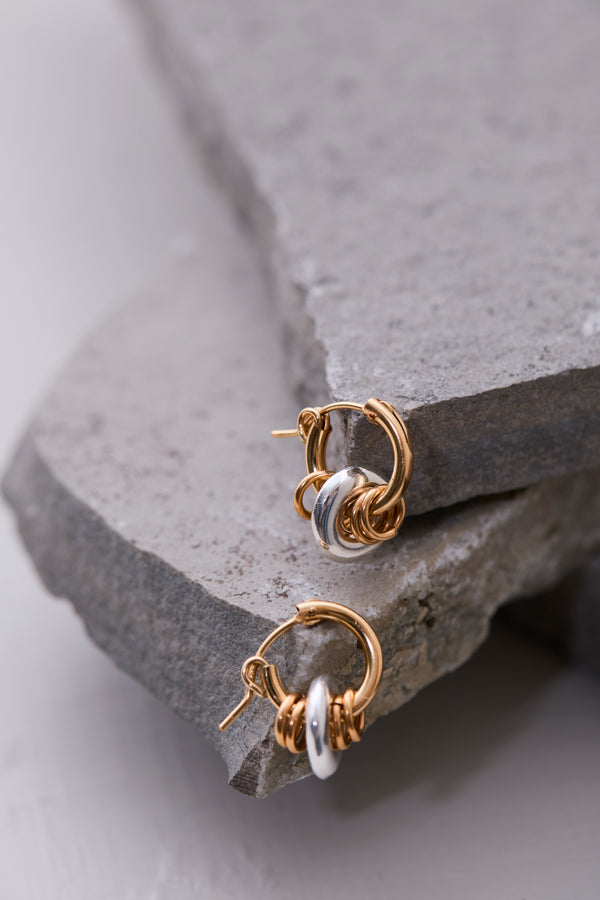 Klas Halo Hoop Earrings on concrete slabs