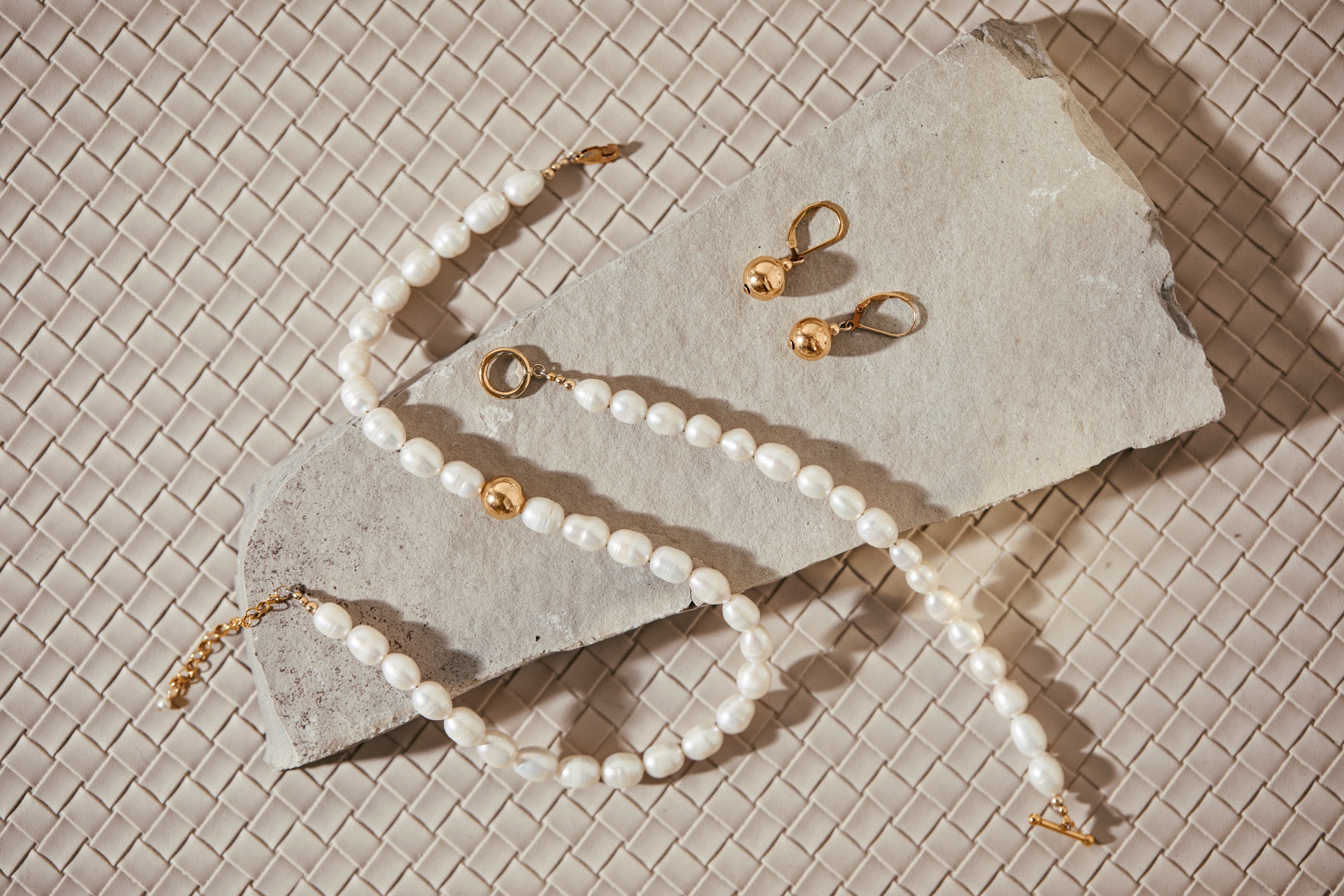 Klas Gold Earrings on concrete slab